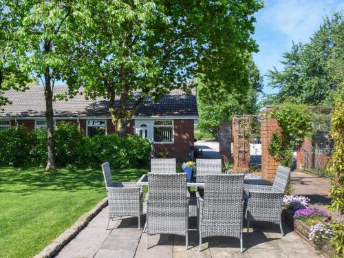 a patio with chairs and a table in a yard at Swallow Cottage - Uk49756 in Little Singleton