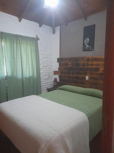 a bedroom with two beds and a window and a bed sidx sidx sidx at Tala in Villa Cura Brochero