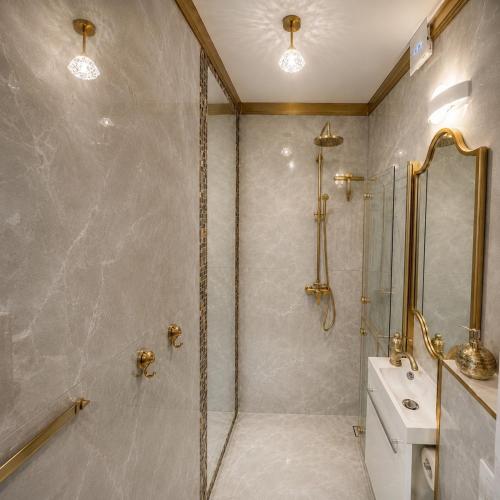 a bathroom with a shower and a toilet and a sink at Maluno vilos apartamentas su terasa in Palanga