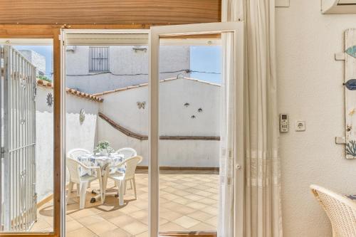 a glass door leading to a patio with a table and chairs at Bahia Studio in Empuriabrava
