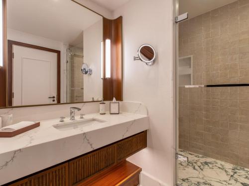 a bathroom with a sink and a shower at Fairmont Cheshire The Mere in Knutsford
