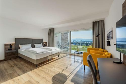 a bedroom with a bed and a large window at Hotel Kapelle in Radolfzell am Bodensee