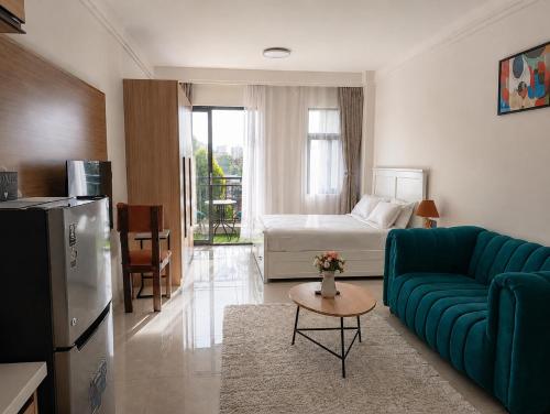 a living room with a couch and a bed at Casa Liora Studio by UN & Two Rivers in Nairobi