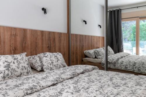 a bedroom with two beds and a mirror at Studio Rimini 523, Kotor in Kotor