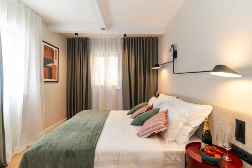 a bedroom with a large bed with pillows on it at Hidden Tree Heritage Hotel in Zadar