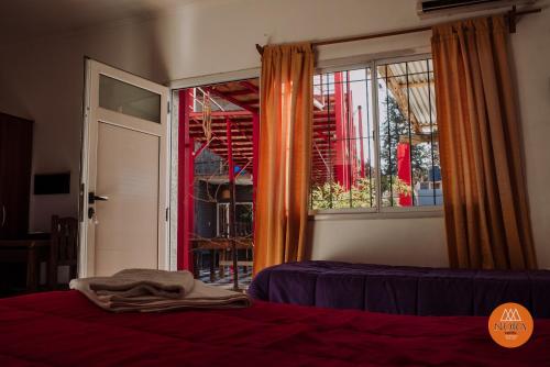 a bedroom with a bed and a window at Hotel Nora in Calingasta