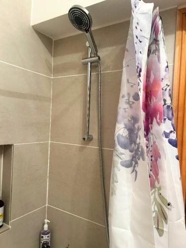 a shower in a bathroom with a shower curtain at Boyne Place in East Hoathly