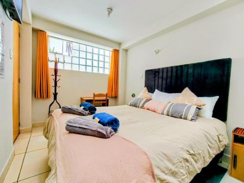 a bedroom with two beds with stuffed animals on them at Killitas home&apart in Cusco