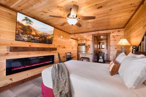 a bedroom with a large bed and a fireplace at The Derby Inn in Hot Springs