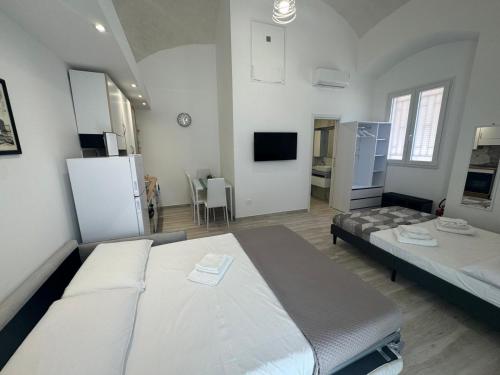 a large room with two beds and a kitchen at South Blue Apartment in Trani
