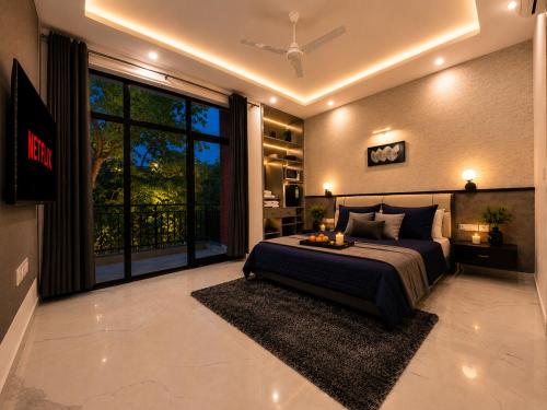 a bedroom with a large bed and a large window at Ace Stayz - Boutique Hotel Near DLF Mall Sector 45, Noida in Noida