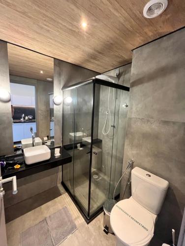 a bathroom with a toilet and a shower and a sink at Maceió - Pajuçara - New Time Apt 516 in Maceió