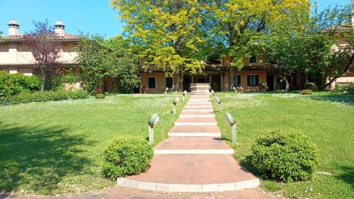 a walkway leading to a building in a park at Villa G in Ravenna