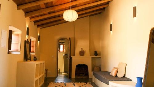 a living room with a couch and a fireplace at Helder Farm Studios in São Teotónio