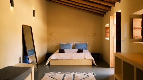 a bedroom with a bed and a television in it at Helder Farm Studios in São Teotónio