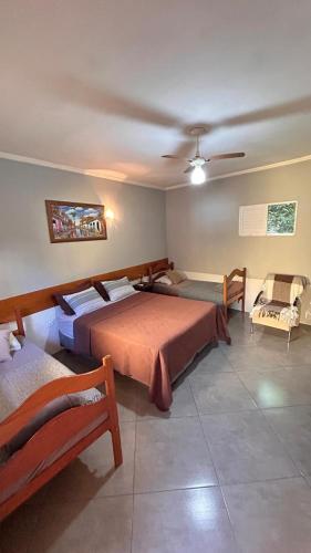 a bedroom with two beds and a ceiling at Pousada Morena Raiz in Ubatuba