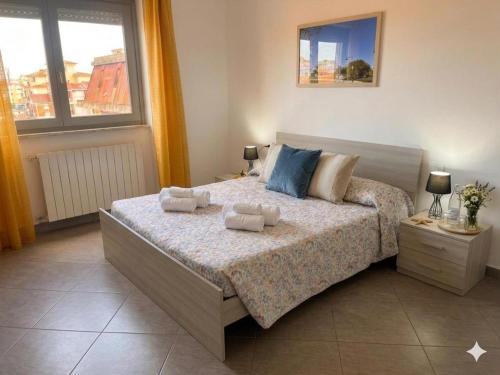 a bedroom with a bed with two towels on it at Casa Angela in Olbia