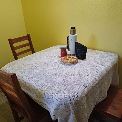 a table with a coffee maker and a plate of food on it at Génesis in Merlo