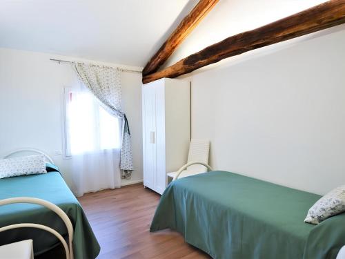 a bedroom with two beds and a window at La Corte di Marga Ginetta 2 - Prosecco Hills Holidays in Miane