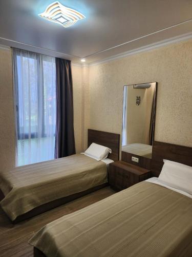 a hotel room with two beds and a mirror at Magnetoria 3 BR House in pine forest - 3 mins to the sea in Urekis Sadguri