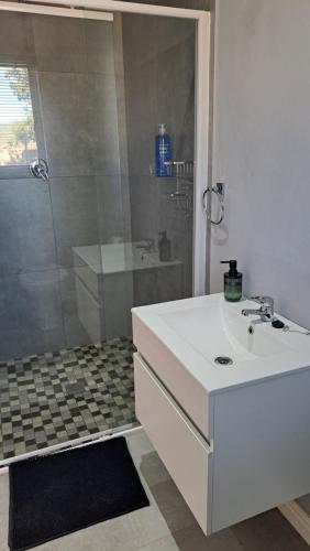 a bathroom with a white sink and a shower at Aqua Farm - Unit 3 in Teba
