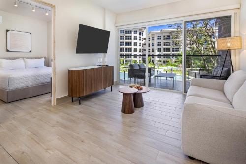 a living room with a bed and a couch and a tv at Olas del Mar by Playa Caracol Resorts in Palmira