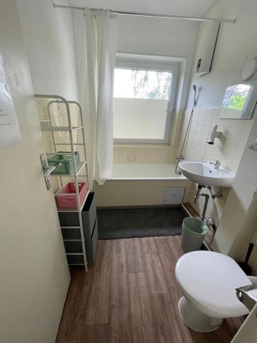 a small bathroom with a toilet and a sink at GM Zimmervermietung in Hamburg