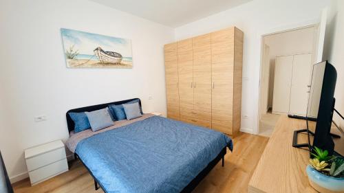 a bedroom with a bed and a television in it at Diana Apartments in Arad