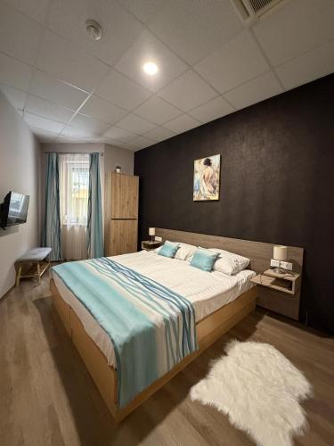 a bedroom with a large bed in a room at Mnd Aqua Nest in Zalakaros