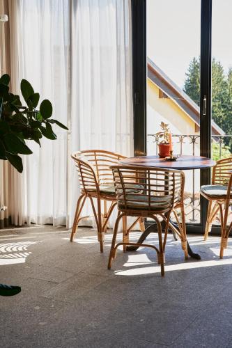 a table and chairs in a room with a table at Albergo Casa Santo Stefano in Miglieglia