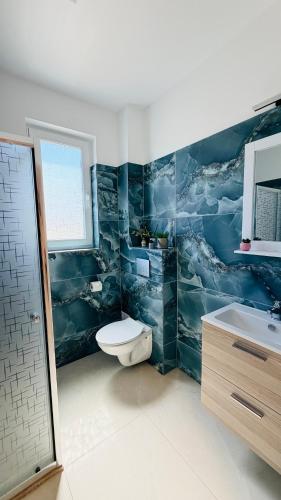 a bathroom with a toilet and a sink at Diana Apartments in Arad