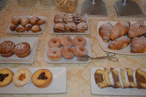 a table full of different types of donuts and pastries at Hotel L'Antico Convitto in Amalfi