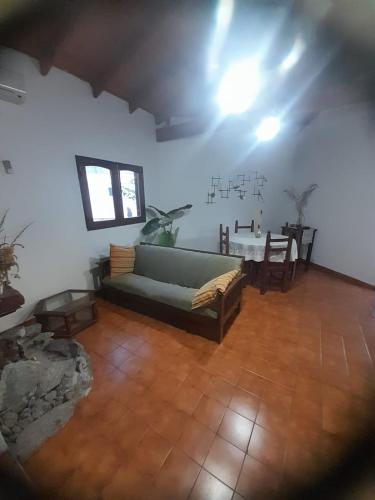 a living room with a couch and a table at tabaquillo in Villa Cura Brochero