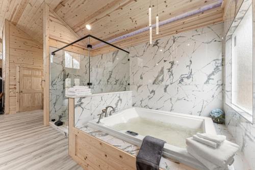 a bathroom with a bath tub in a room at Hilltop Haven Treehouse in Cornelia