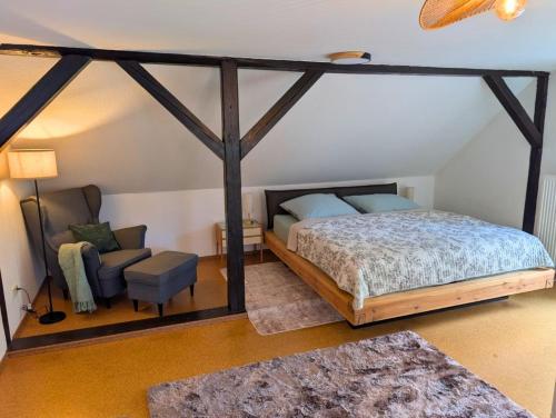 a bedroom with a canopy bed and a chair at Hofidyll Burg - ruhige 75qm FeWo im Zentrum mit Terrasse & Biergarten - bis 6 Personen in Burg