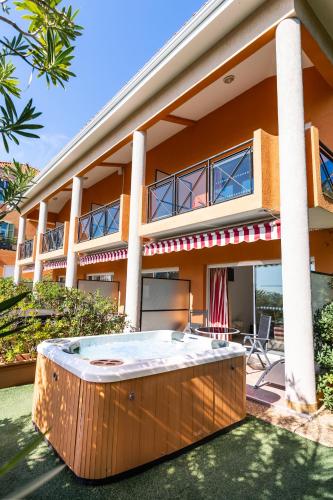 a large house with a hot tub in front of it at Hôtel La Flore in Villefranche-sur-Mer