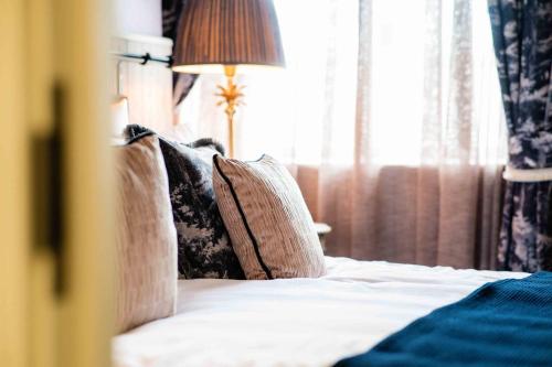 a bedroom with a bed with pillows and a window at The Nest at The Woodmans in Whickham