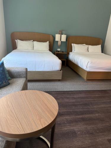 a room with two beds and a couch and a table at Element by Marriott Sedona in Sedona