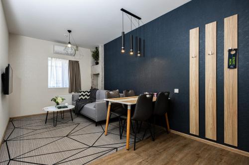 a living room with a table and a couch at Amarant Apart Hotel by CHM in Kyiv
