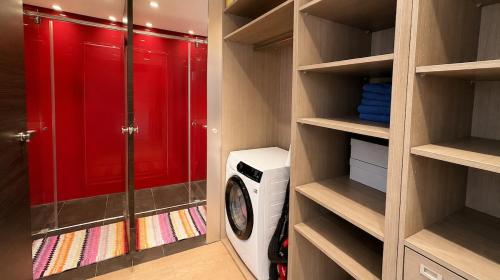 a walk in closet with a washing machine in it at Antwerp Design Stay with Panoramic River Views in Antwerp