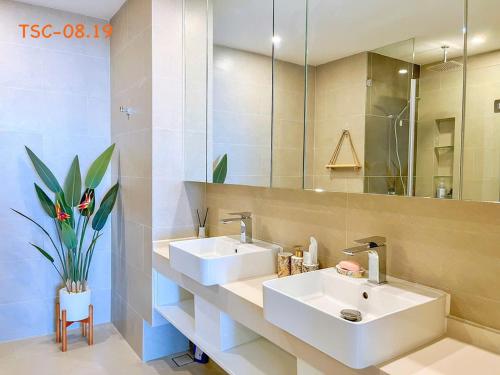 a bathroom with two sinks and a large mirror at CĂN HỘ CAO CẤP THE SONG VŨNG TÀU - LUXURY APARTMENT THE SÓNG VŨNG TÀUs in Vung Tau