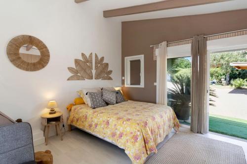 a bedroom with a bed and a large window at Le Pape - Chambre in Porticcio