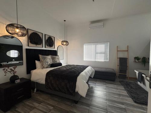 a bedroom with a bed and a television in it at ikibiki in Beaufort West