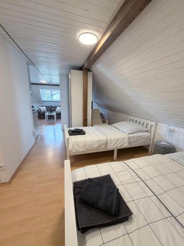 a room with two beds in a attic at Top-floor apartment for up to 3 guests in Dreieich