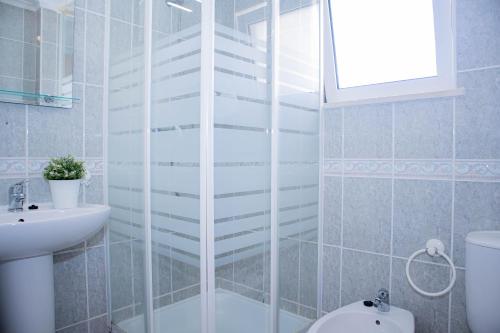 a bathroom with a shower and a toilet and a sink at Villa BelaVista with Private Pool in Ferragudo