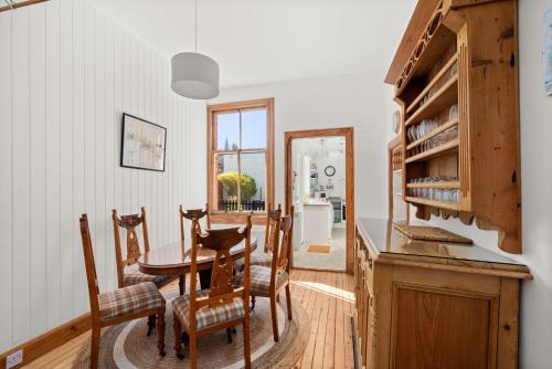a kitchen and dining room with a table and chairs at Heywood Cottage in St. Andrews