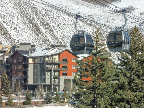 two gondolas on a ski lift over a city at Avon Resort 2BR Suite in Avon