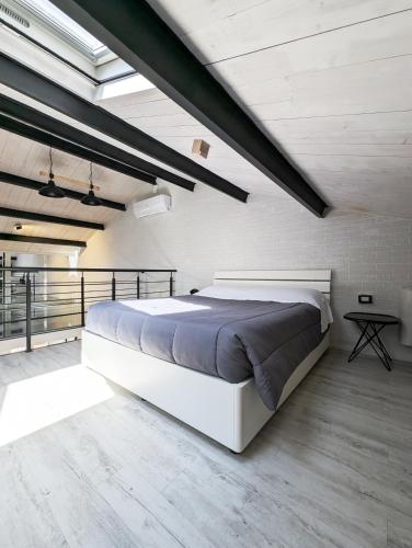 a bedroom with a large white bed in a room at The Superhost - The Loft in Crotone