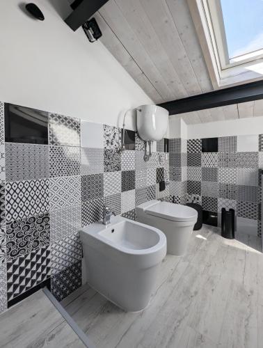a bathroom with a toilet and a bidet at The Superhost - The Loft in Crotone