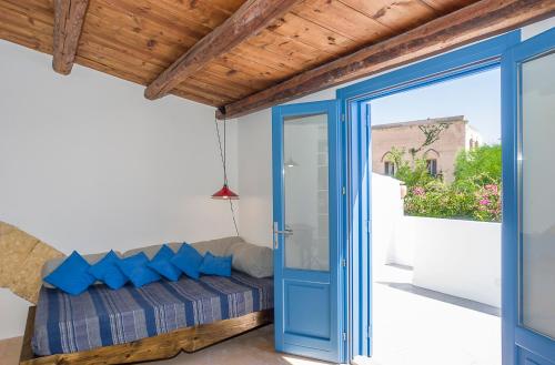 a room with a blue door and a balcony at Vero Sicily - Balloniera In Solanto in Santa Flavia